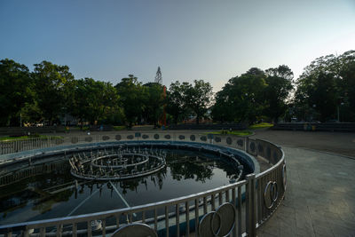 View of swimming pool in city against clear sky