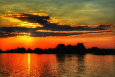 Scenic view of lake against romantic sky at sunset