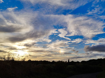 Scenic view of field against sky at sunset