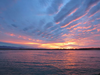 Scenic view of sea against romantic sky at sunset