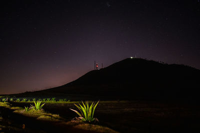 Scenic view of silhouette mountain against sky at night