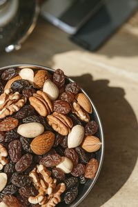 High angle view of roasted coffee beans in bowl on table