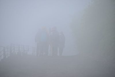 Woman standing in foggy weather