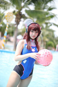 Young woman with arms raised in swimming pool