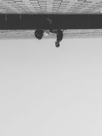 Low section of man against clear sky