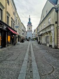 Street amidst buildings against sky in city