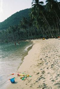 People on beach against sky