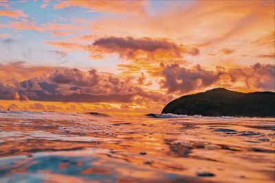 Scenic view of sea against orange sky