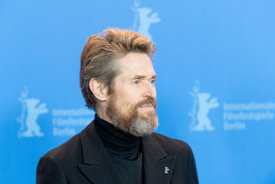 Close-up of mature man against blue sky