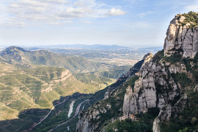 Scenic view of mountains against cloudy sky