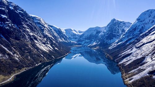 Scenic view of snowcapped mountains against clear blue sky