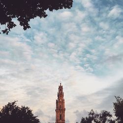 Low angle view of building against cloudy sky