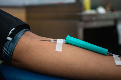 Midsection of doctor holding syringe