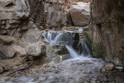 The waterfall and running river across the sandstone rocks