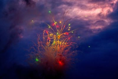 Low angle view of firework display at night