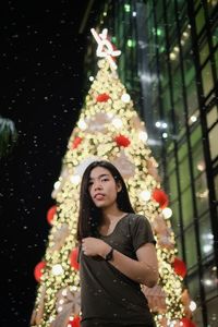 Portrait of woman with christmas tree