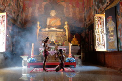 Statue in temple outside building