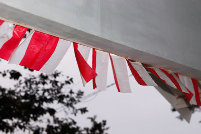 Low angle view of flags hanging from roof