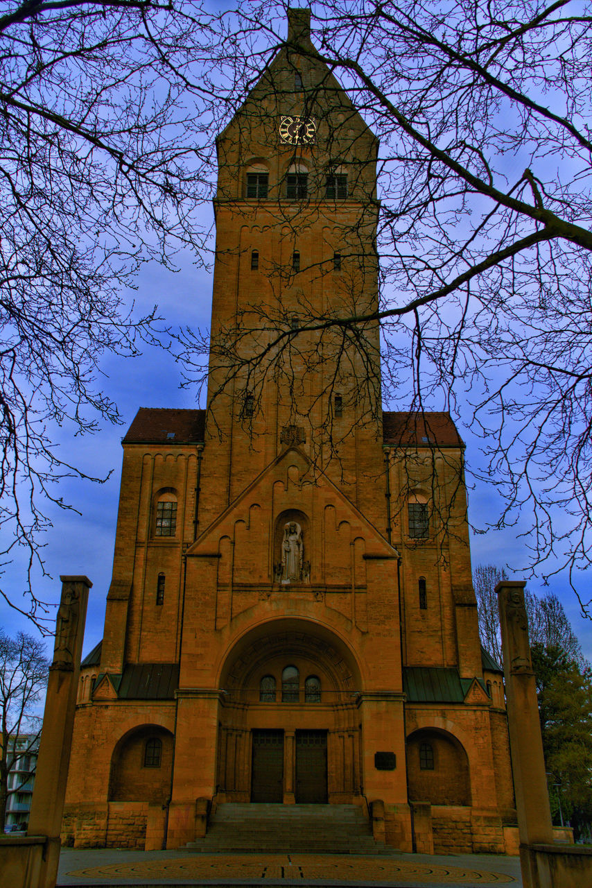 LOW ANGLE VIEW OF CLOCK TOWER AGAINST BLUE SKY