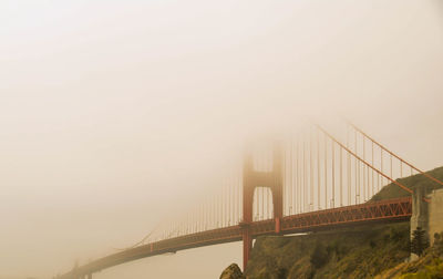 View of suspension bridge in foggy weather