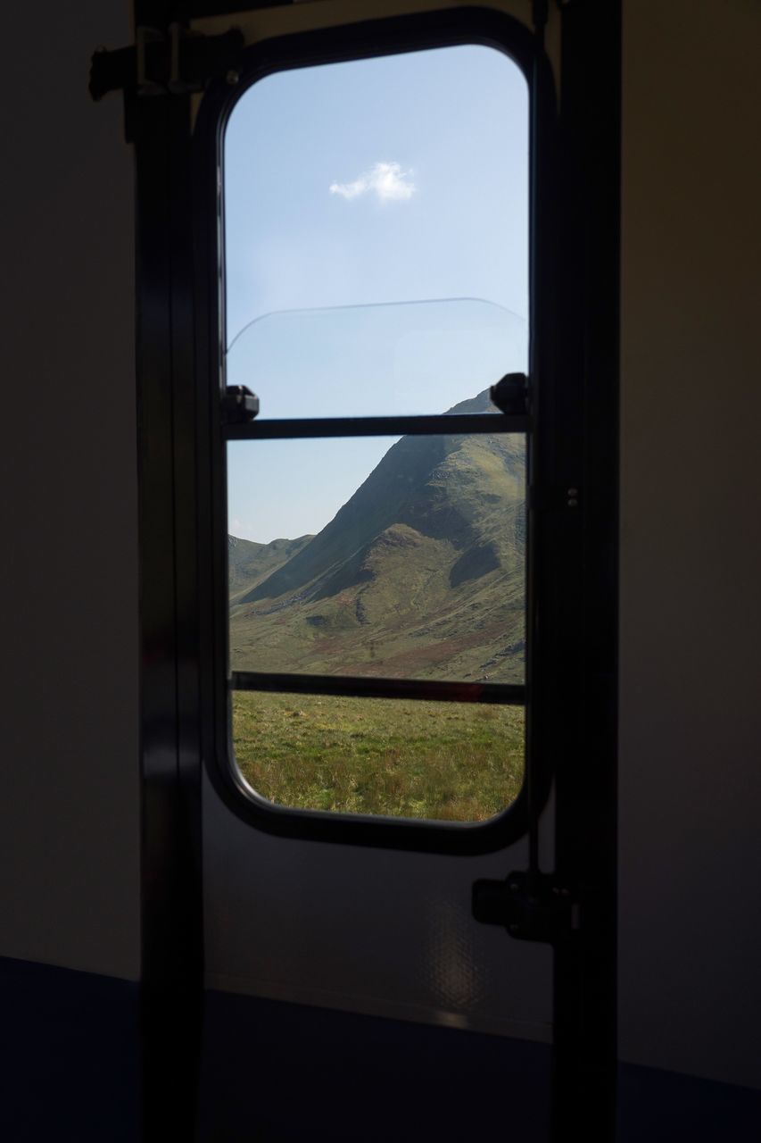 window, sky, transparent, glass - material, landscape, mode of transportation, environment, nature, transportation, vehicle interior, no people, indoors, train, travel, land, beauty in nature, day, scenics - nature, field