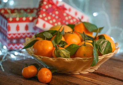 Close-up of orange fruits in basket on table