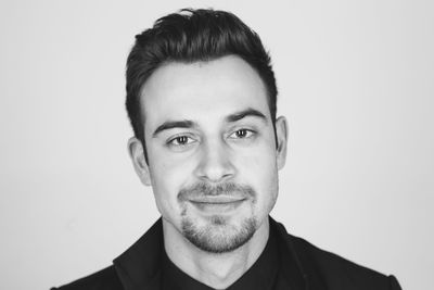 Portrait of young man against white background