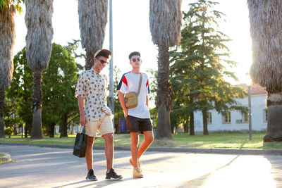 Rear view of couple walking on footpath
