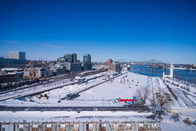 High angle view of cityscape against clear blue sky