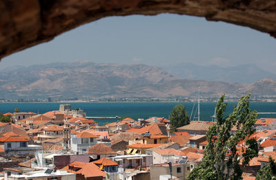 Townscape by sea against sky