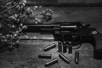 Close-up of gun and bullets on table