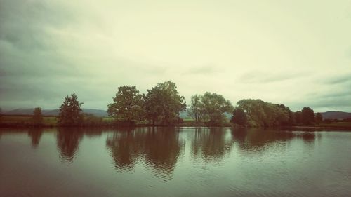 Scenic view of lake against cloudy sky