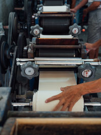 Cropped hands of worker working in factory