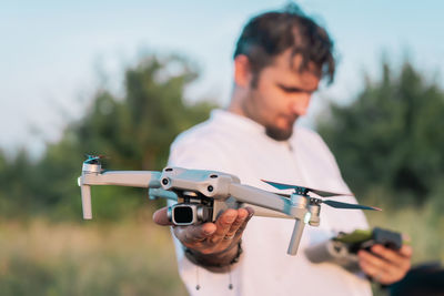 Close-up of man holding drone