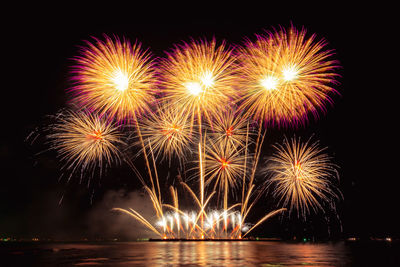 Low angle view of firework display at night