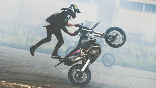 Full length of man riding motorcycle