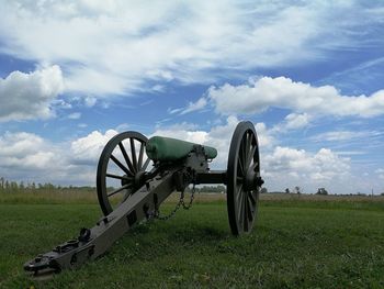 Horse cart on field against sky