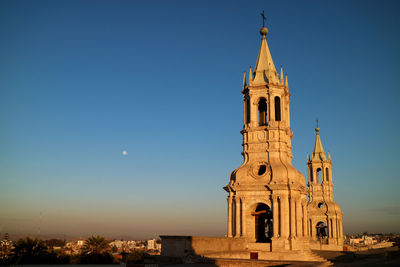 Impressive bell tower of basilica cathedral of arequipa with the morning moon, arequipa, peru