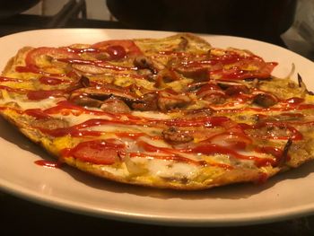 Close-up of pizza served on plate