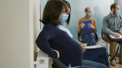 Side view of woman using digital tablet at home