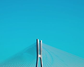 Low angle view of metallic structure against blue sky