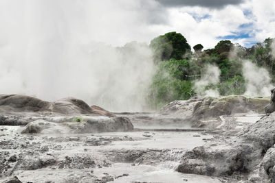 Scenic view of waterfall against sky