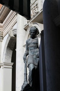 Low angle view of statue against historic building