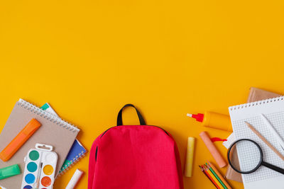 High angle view of objects on yellow background