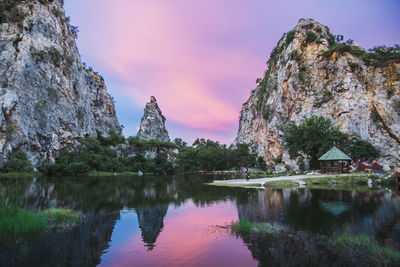 Scenic view of lake by rock formation against sky