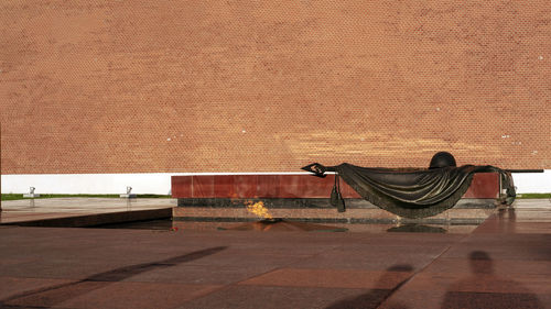 Man on bench against wall