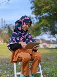 Full length of girl using tablet for online classroom 