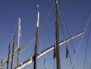 Low angle view of sailboat against clear sky