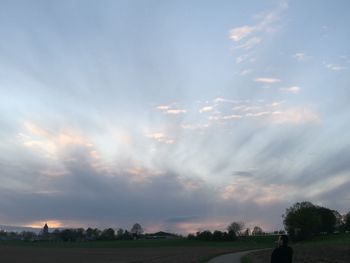 Scenic view of field against sky during sunset