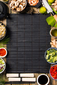 Directly above shot of place mat amidst various food on table